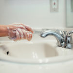 Handwashing over the sink with soap to protect from coronavirus infection