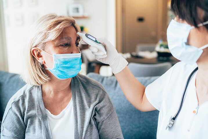 Woman getting her temperature taken