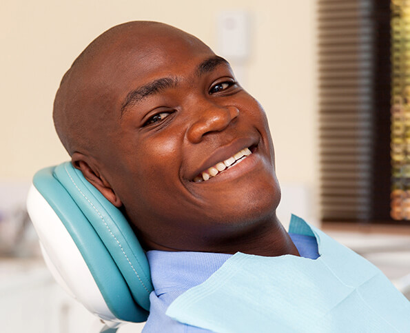 smiling man sitting in a dental chair