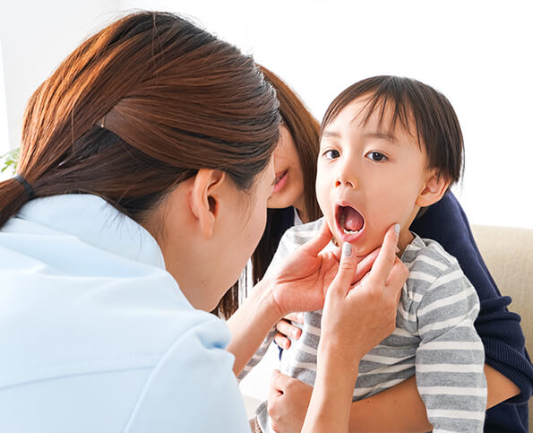 dentist examining a young boy's teeth